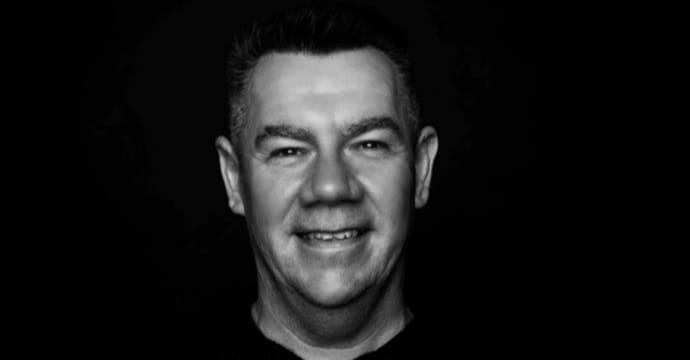 A person with a serious expression in a dark setting | MSC Cruises