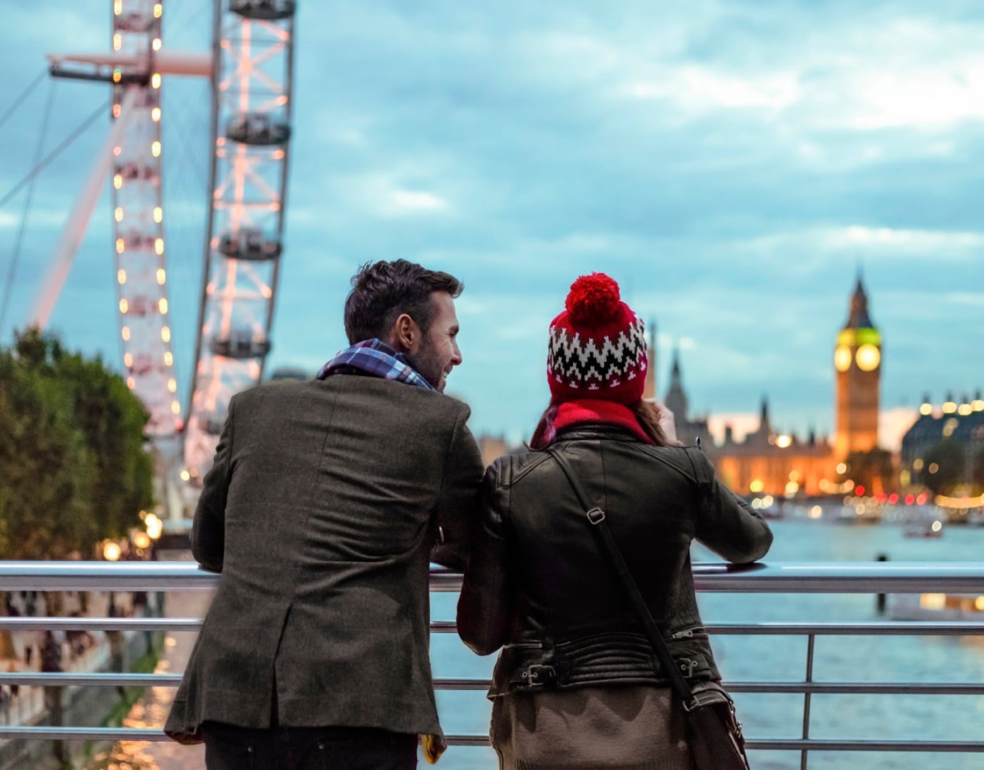 A couple enjoying a scenic view of London with the Eye and Big Ben in the background | MSC Cruises A couple enjoying a scenic view of London with the Eye and Big Ben in the background | MSC Cruises