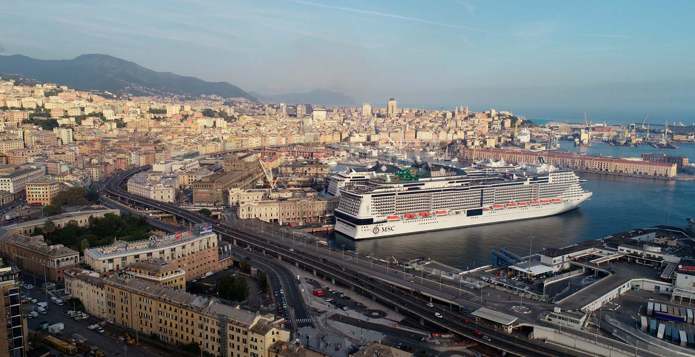 MSC cruise ship docked in a scenic port city with hills and historic buildings | MSC Cruises