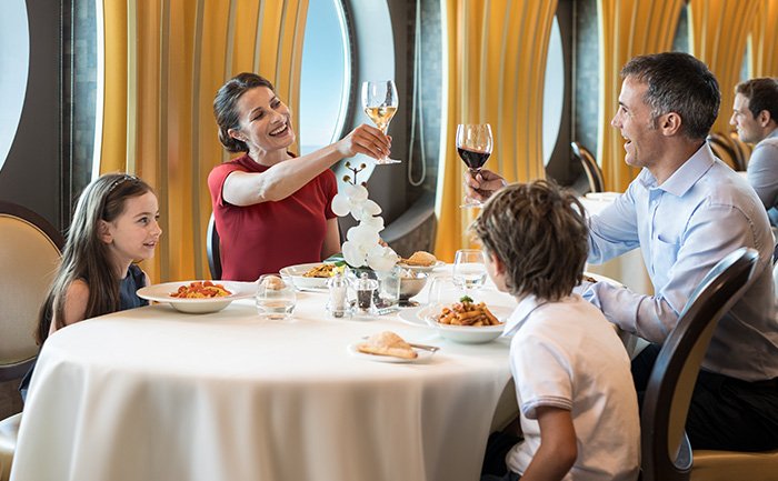 Family enjoying fine dining in an elegant restaurant with ocean views | MSC Cruises