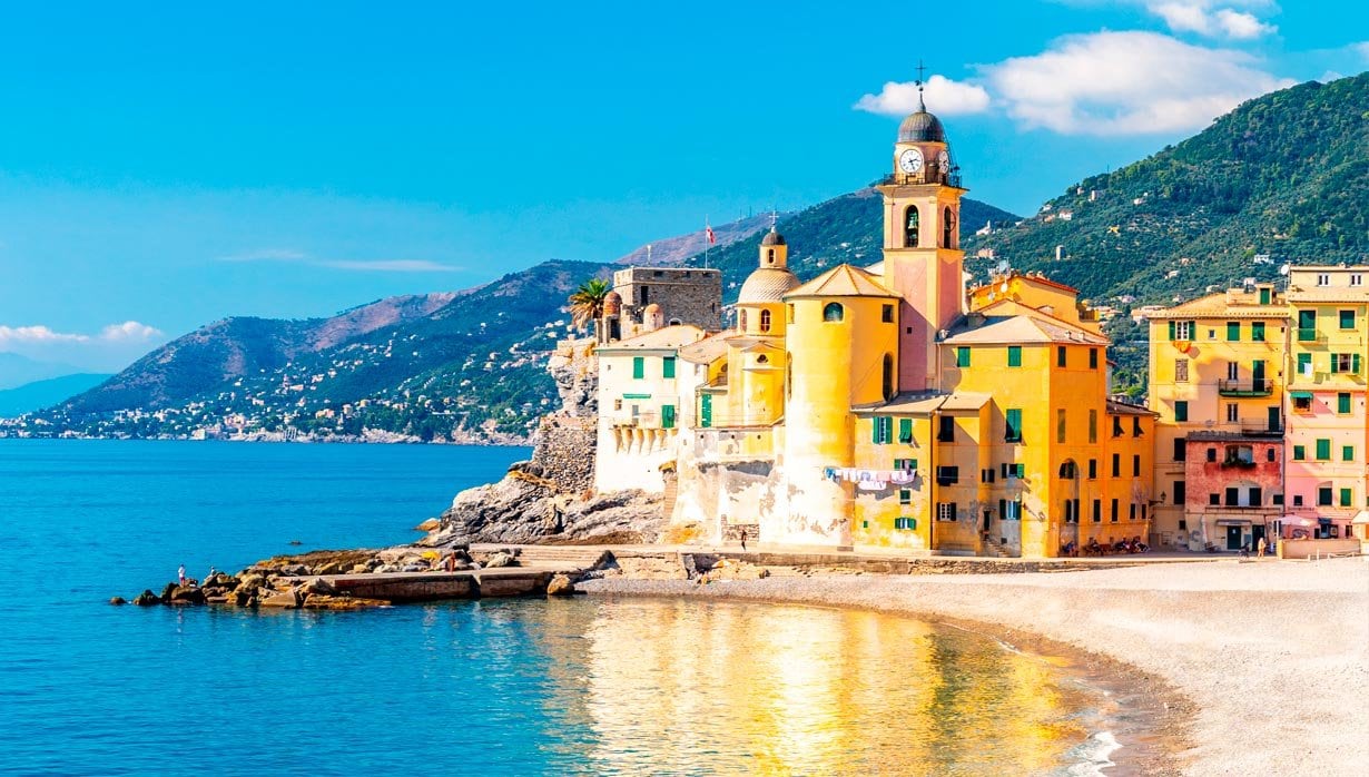 Colorful seaside village with a historic clock tower overlooking the Mediterranean | MSC Cruises Colorful seaside village with a historic clock tower overlooking the Mediterranean | MSC Cruises